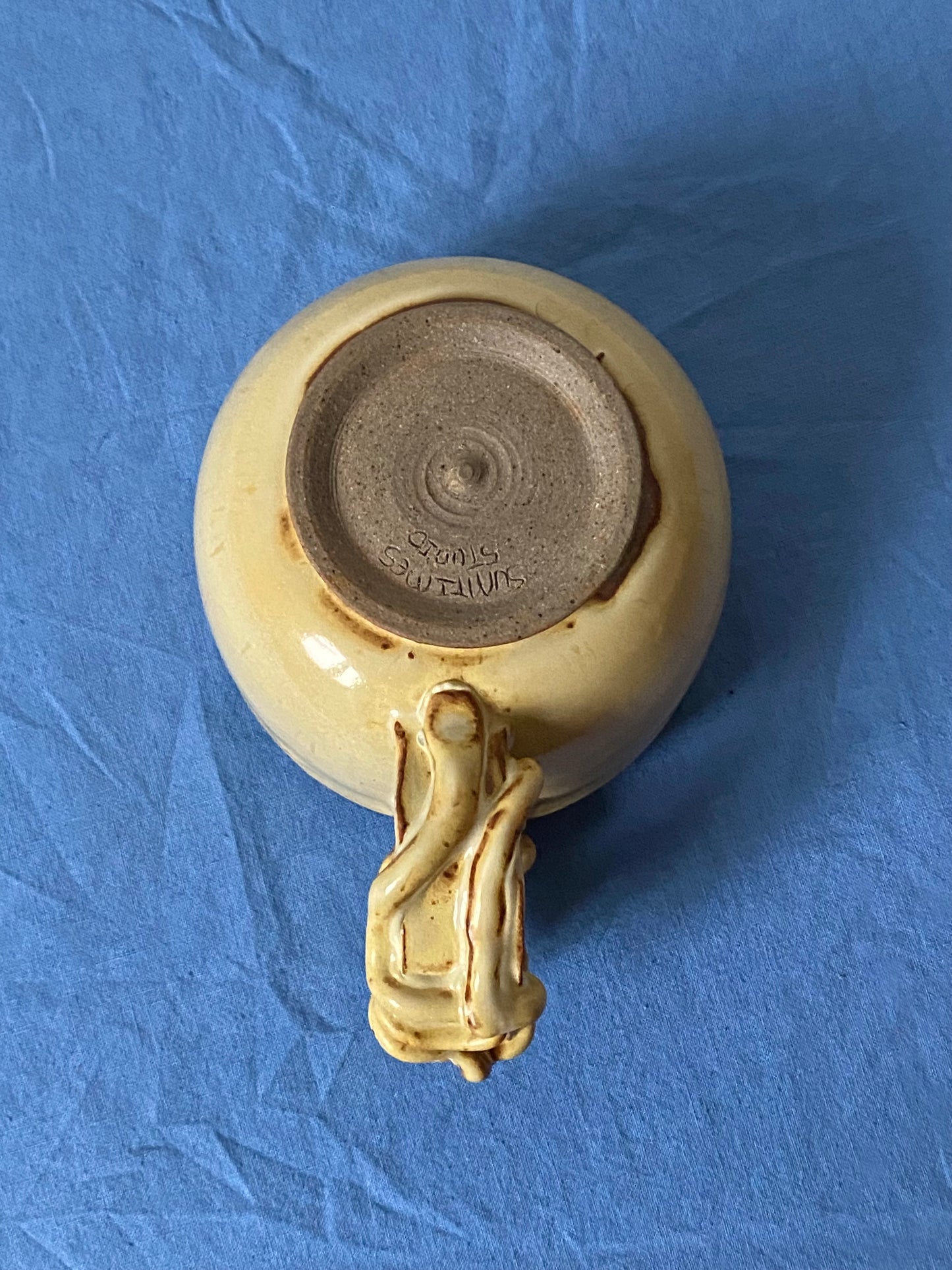 Yellow cream mug with coily handle