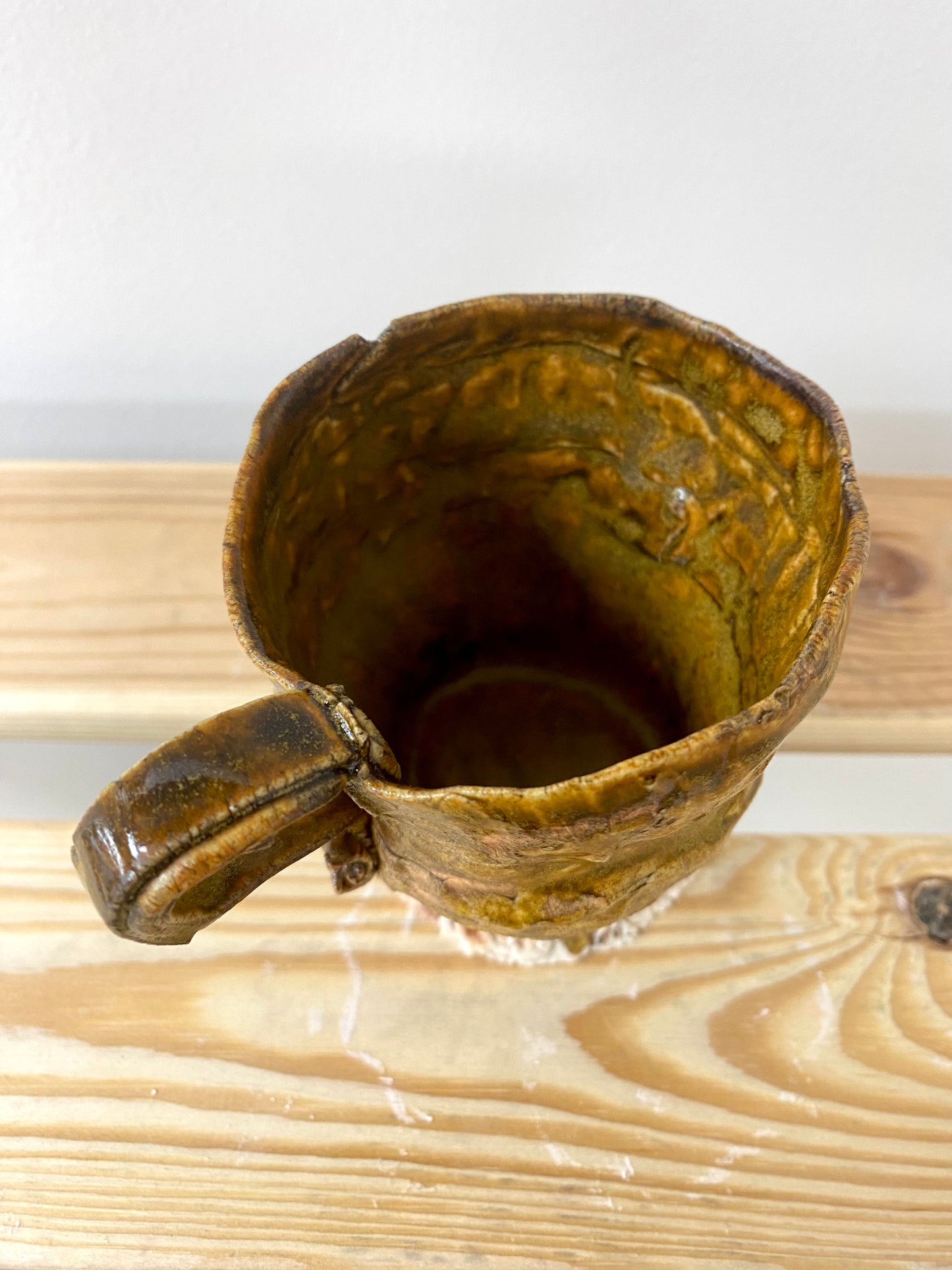 Small greenish amber porcelain cup