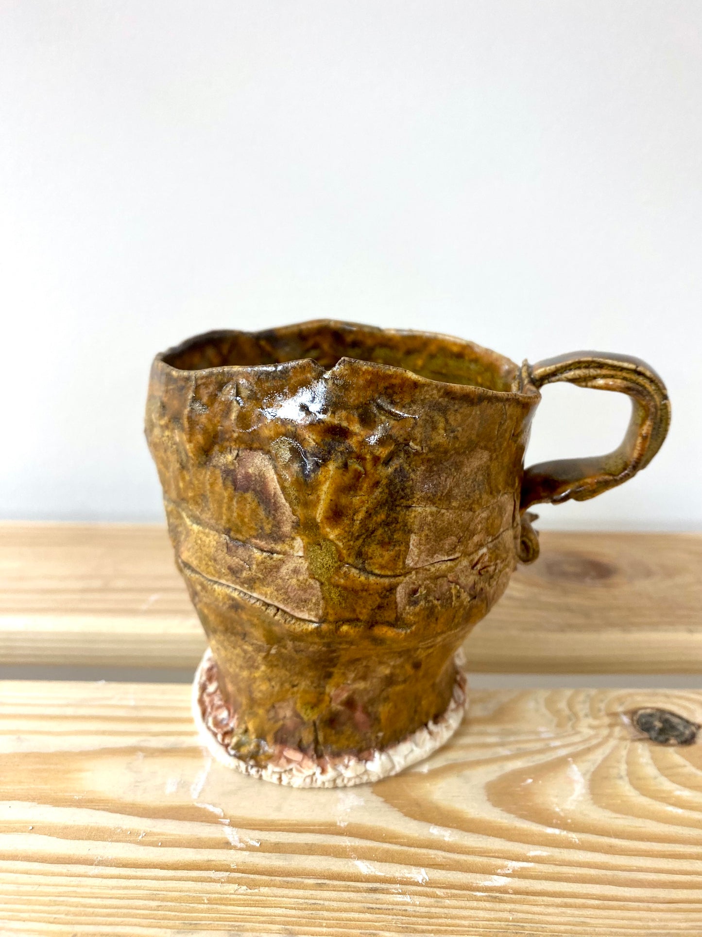 Small greenish amber porcelain cup