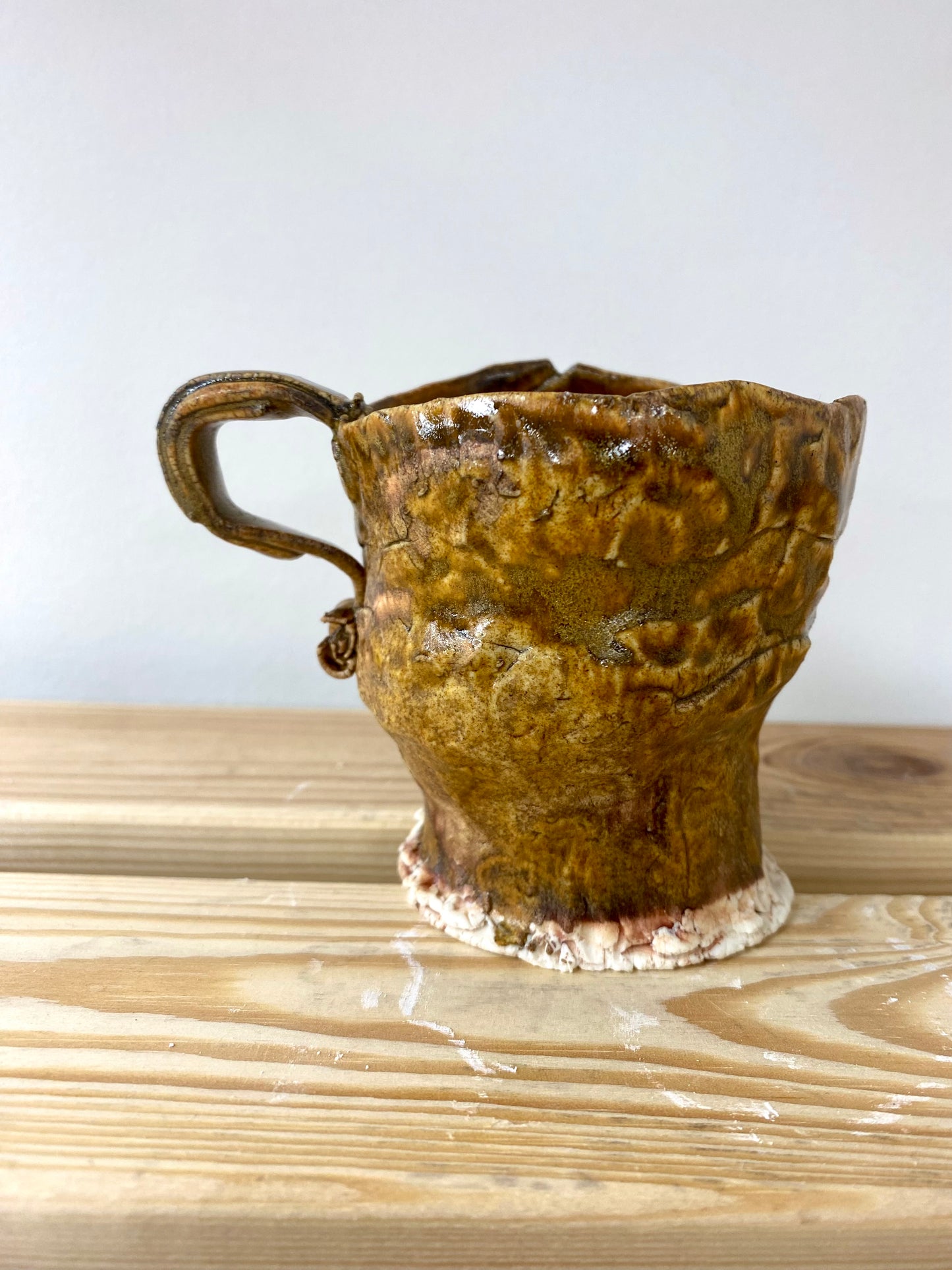 Small greenish amber porcelain cup