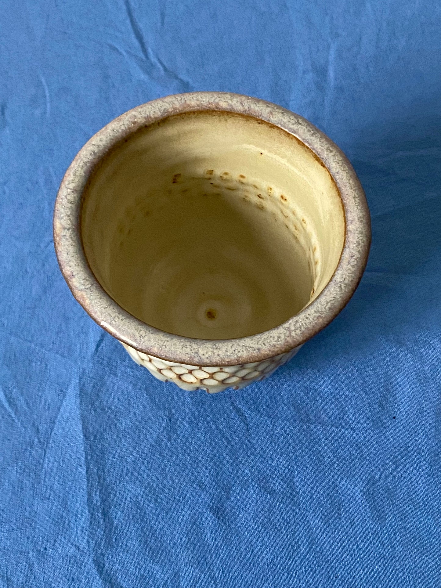 Cream tumbler with circular indentations