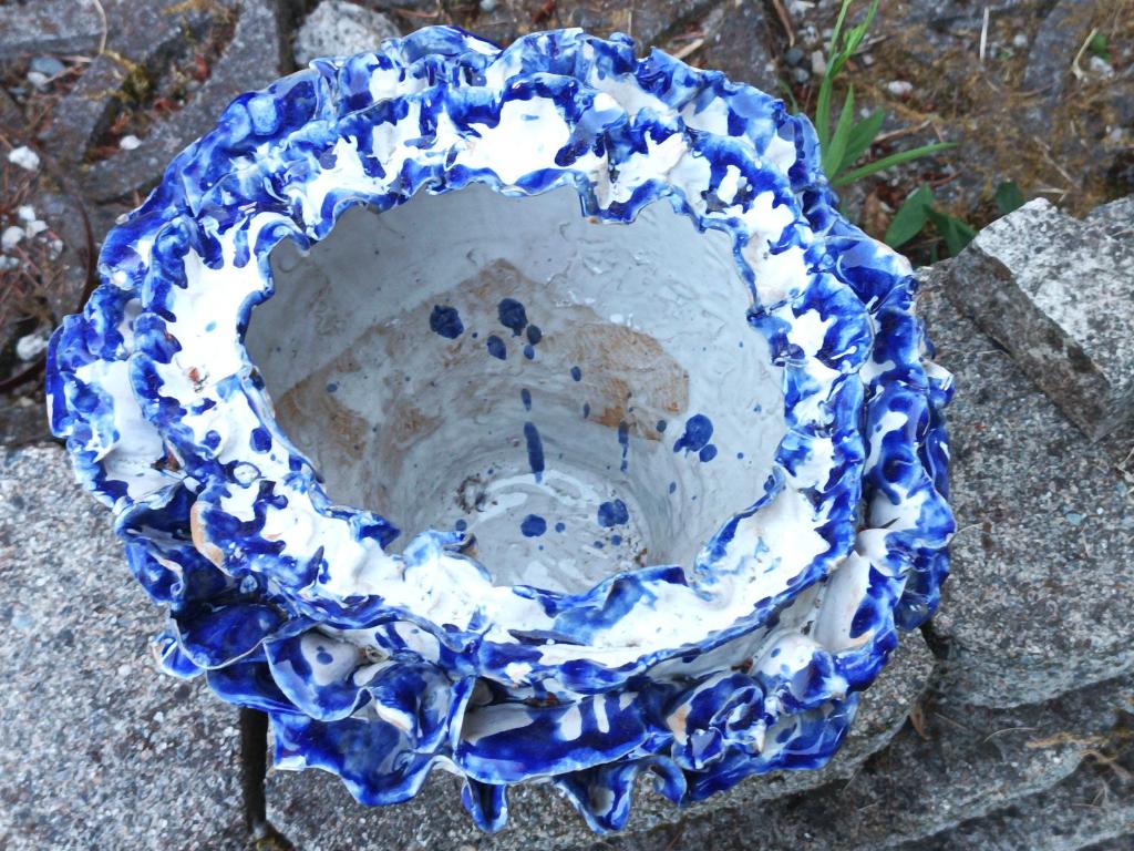 White flower pot with blue petals