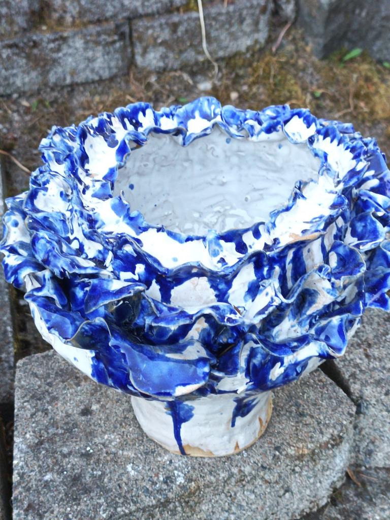 White flower pot with blue petals