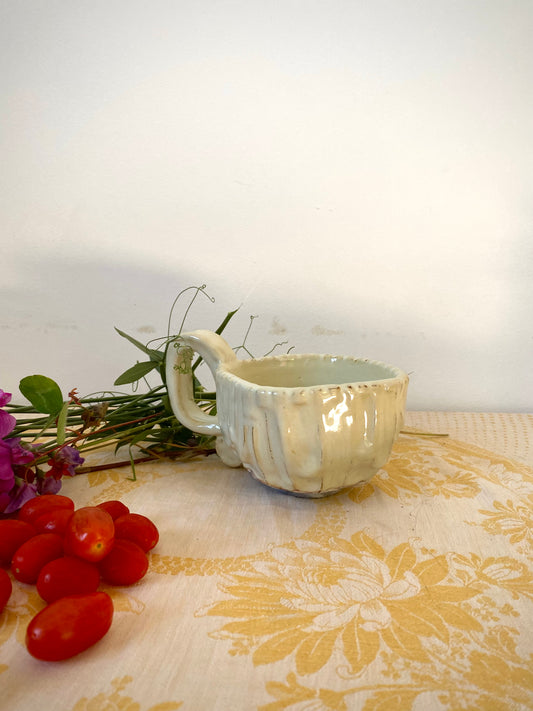 Cream colored mug with squared shape