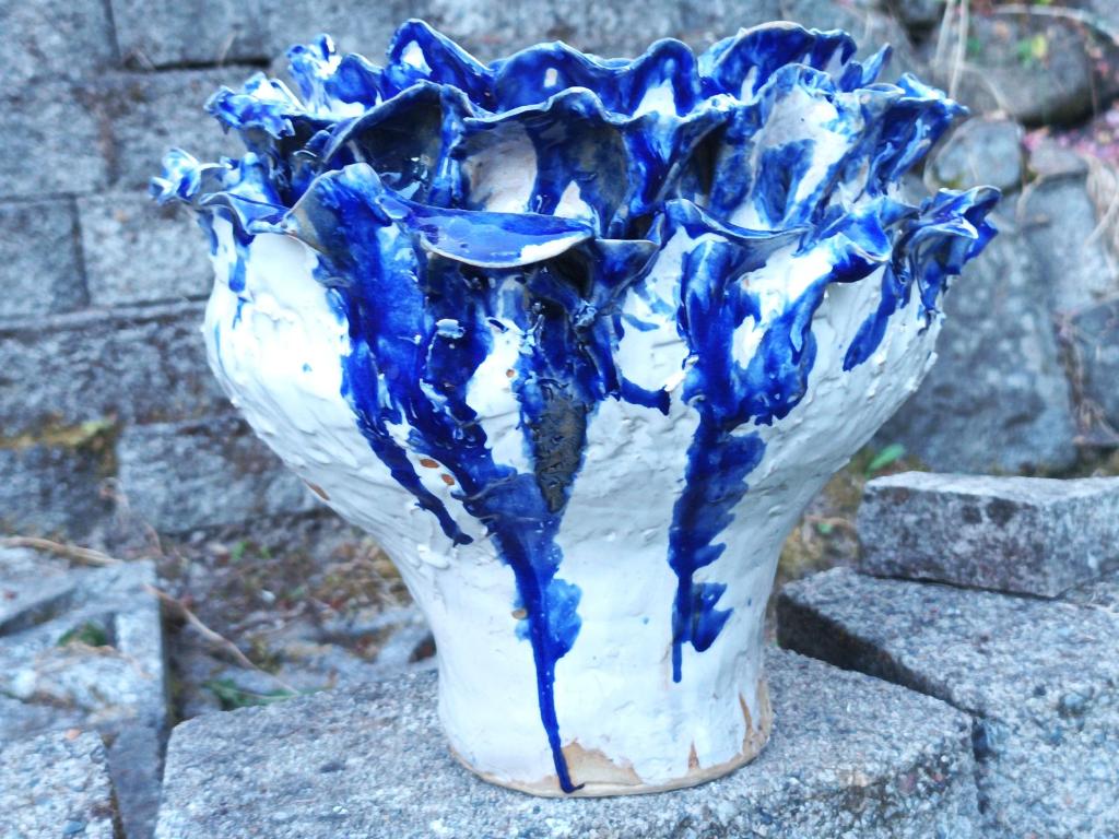 White flower pot with blue petals