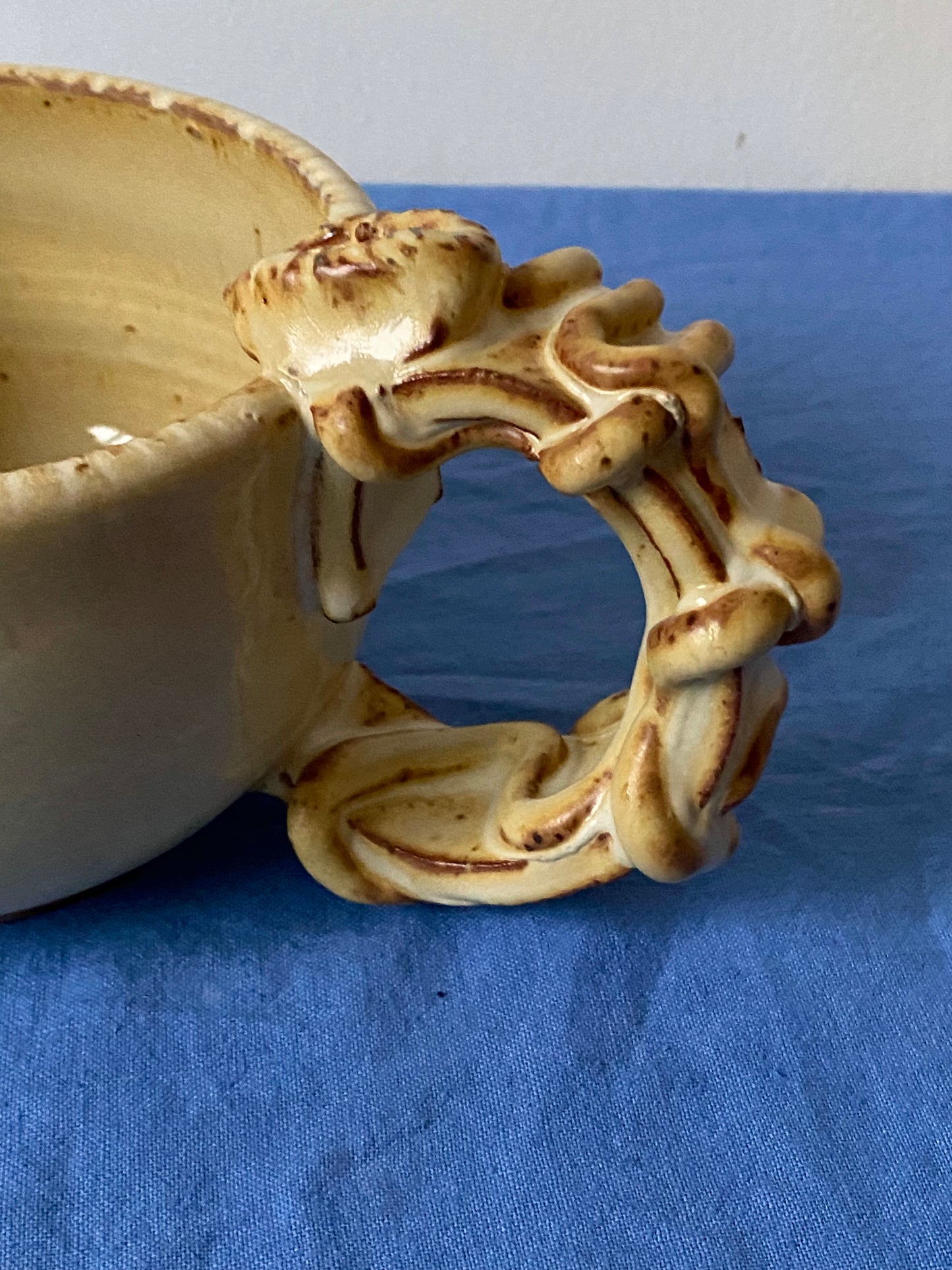 Yellow cream mug with coily handle