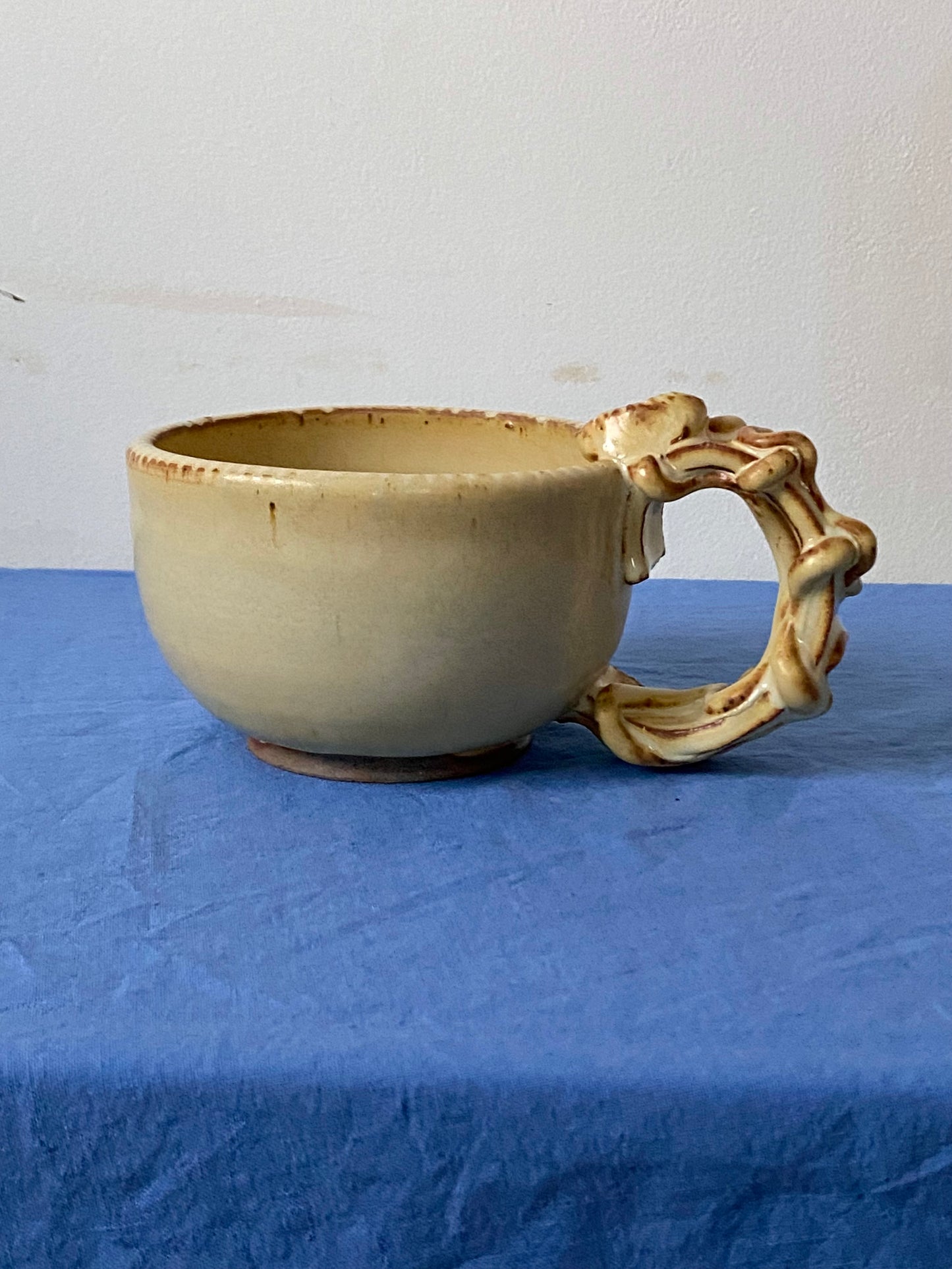Yellow cream mug with coily handle