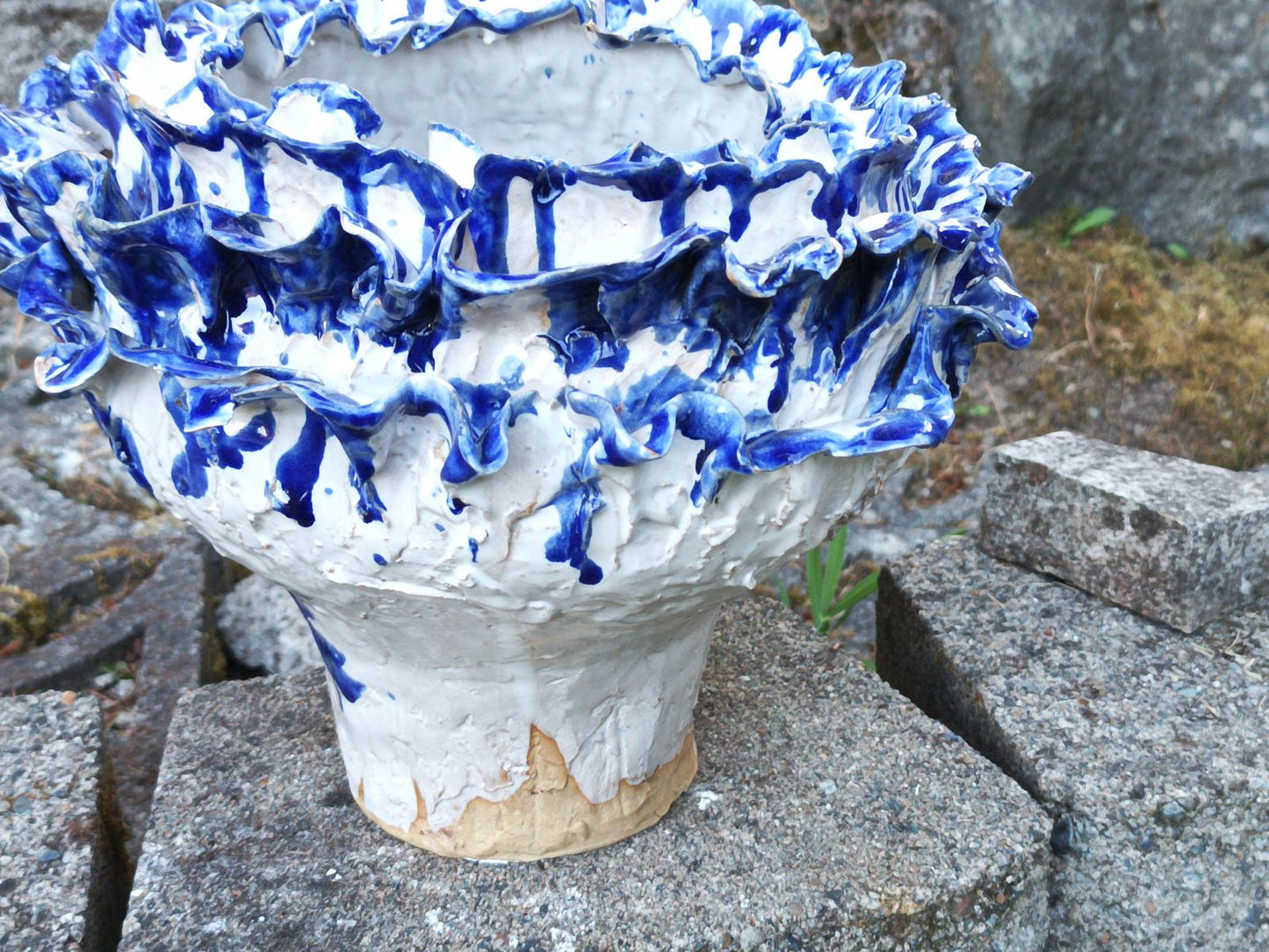 White flower pot with blue petals