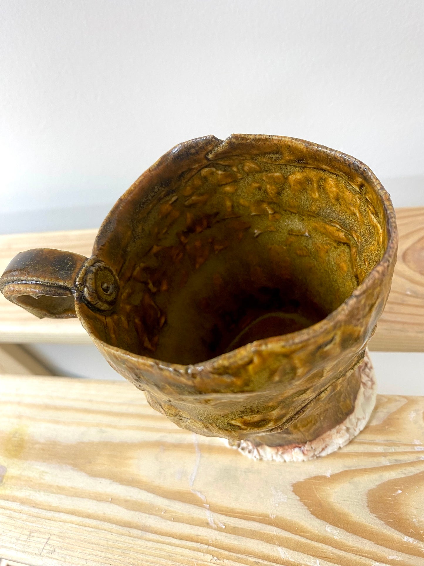 Small greenish amber porcelain cup