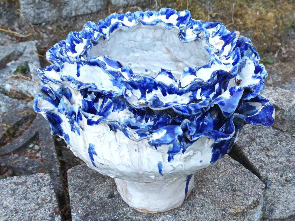 White flower pot with blue petals