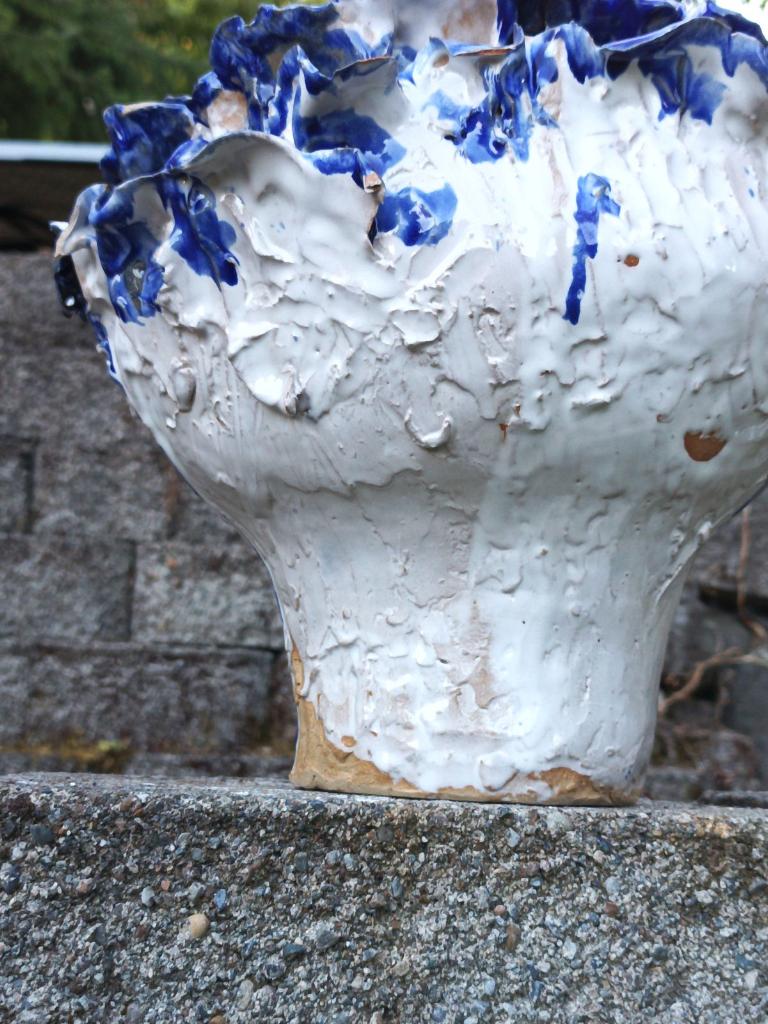 White flower pot with blue petals