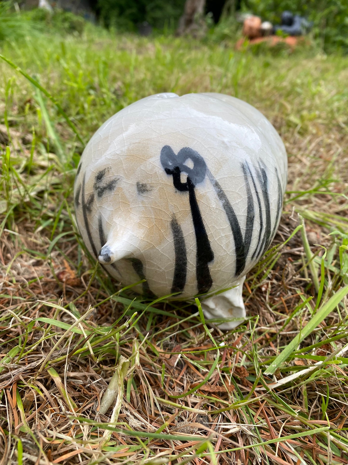 Beast piggy bank with grass