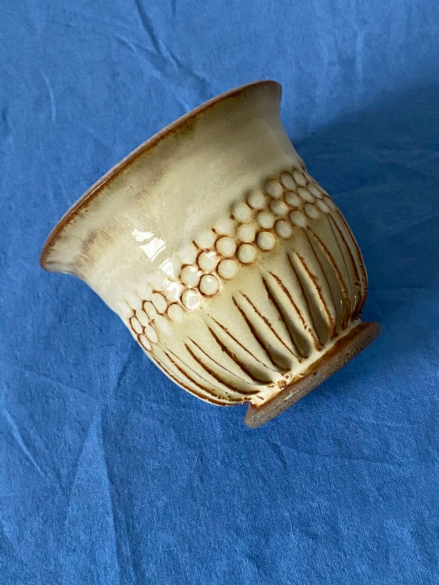 Cream tumbler with circular indentations