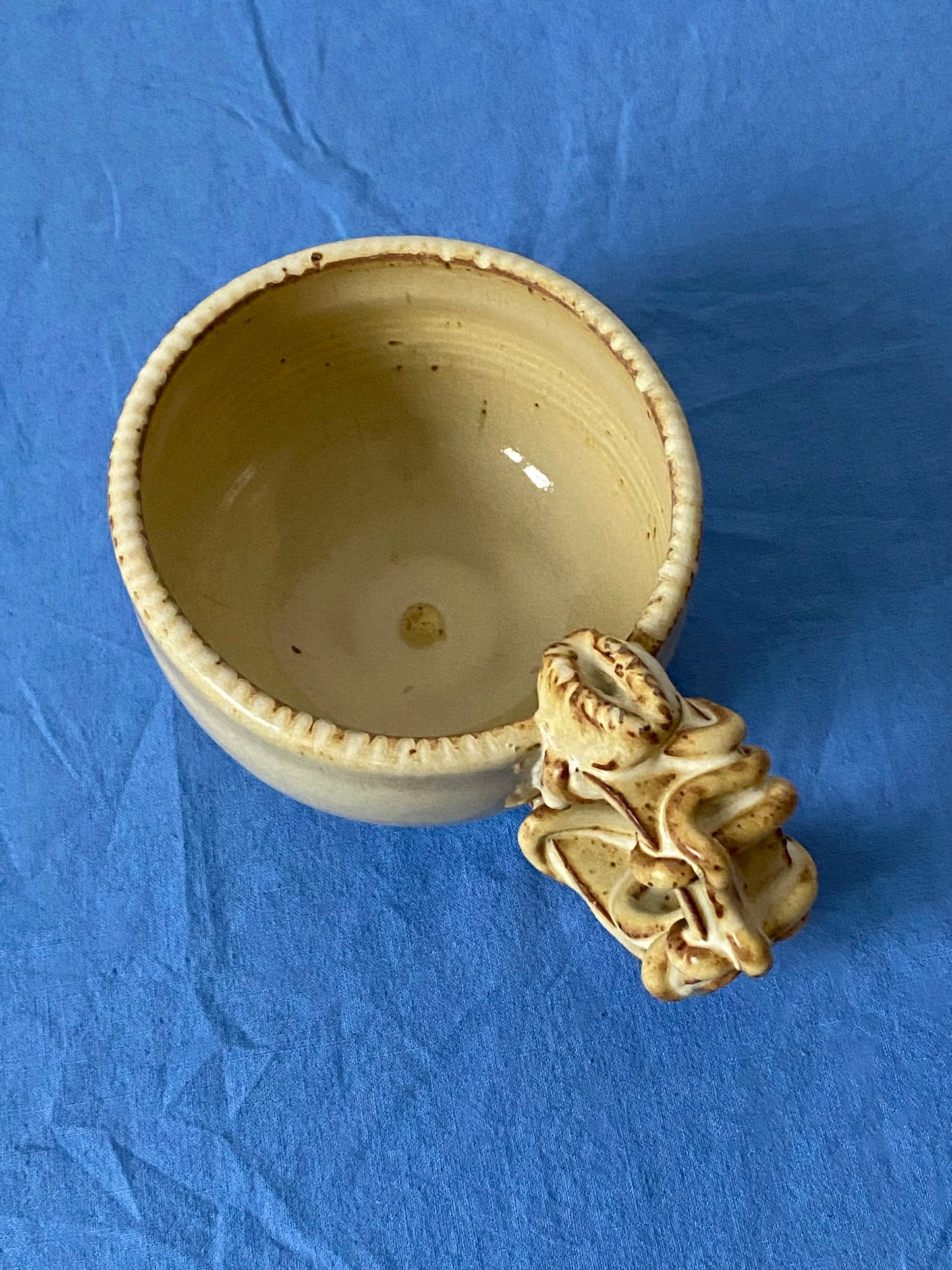 Yellow cream mug with coily handle