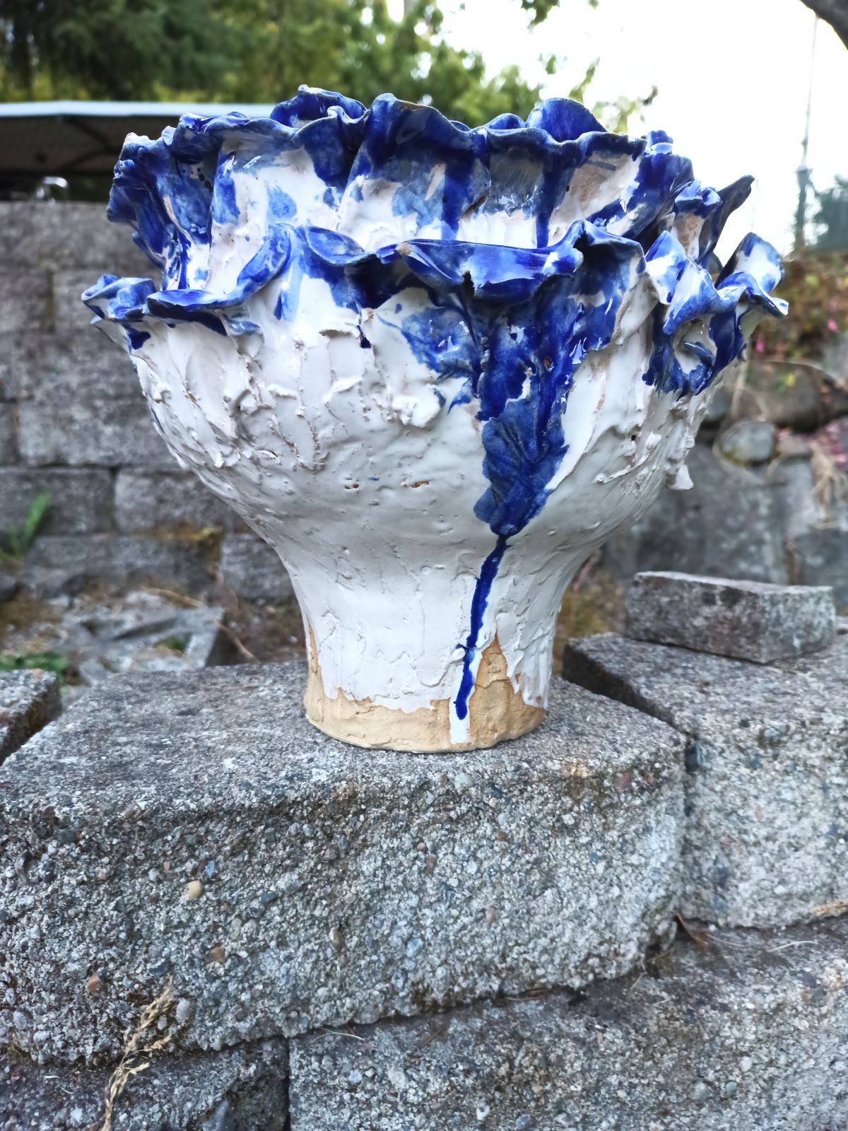 White flower pot with blue petals