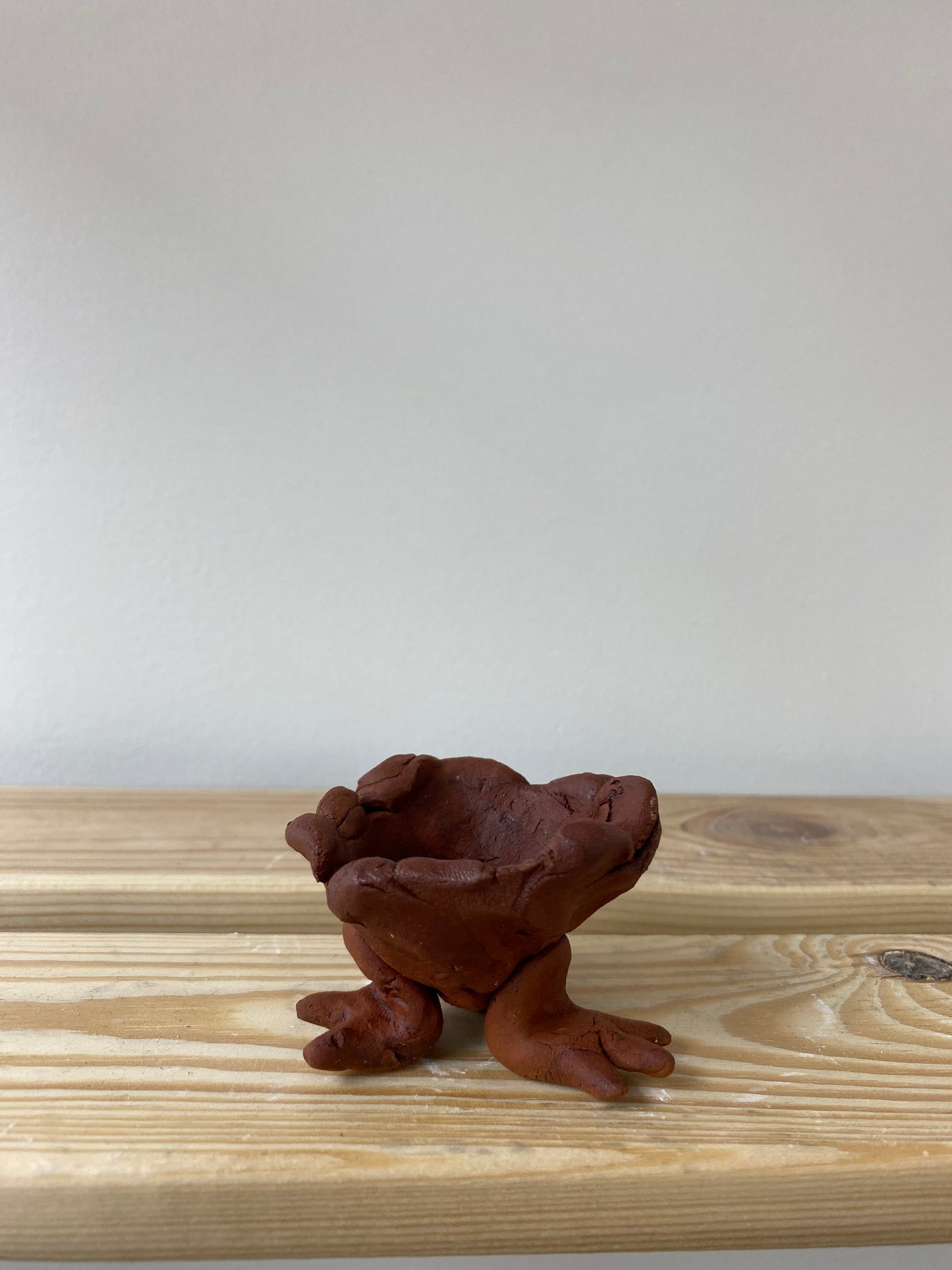 Smol terracotta candlestick with feet